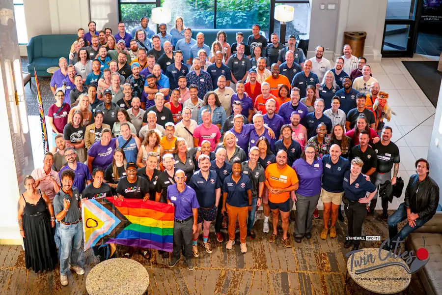 Stonewall Sports National Tournament group photo with Pride flag